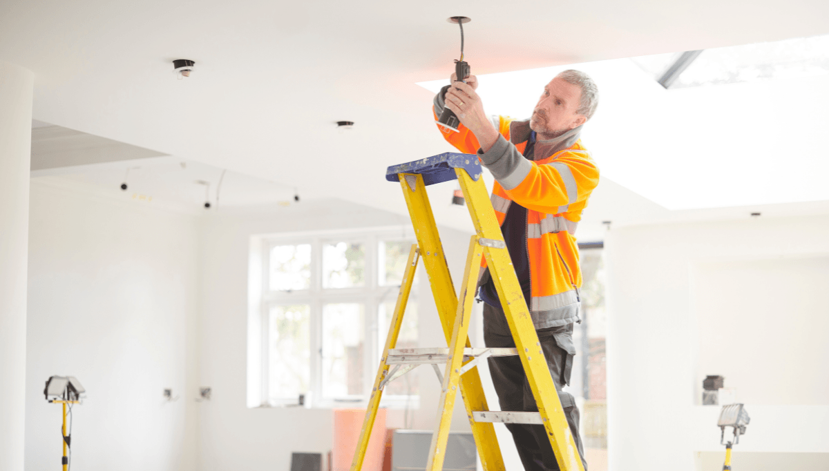 Electrician on site checking the install before quoting
